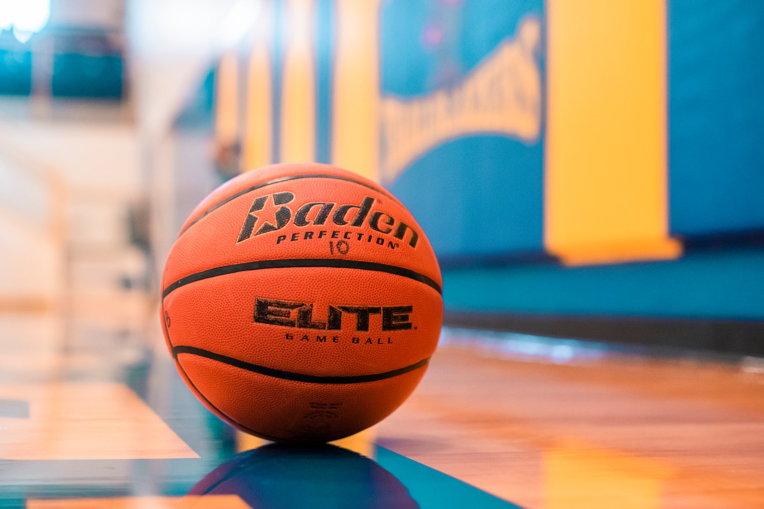A basketball sits on a gym floor during practice at Centralia College in February 2021.